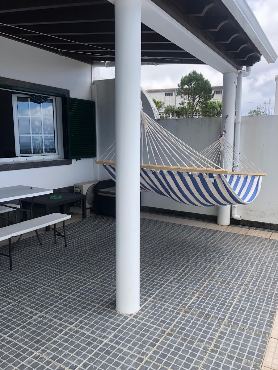 Covered terrace seating and hammock at Casa da Adega
